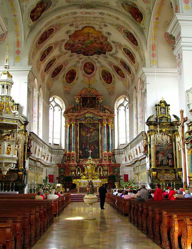 Central aisle of the Basilica of St. Peter in Dillingen with a view of the apse and altars.